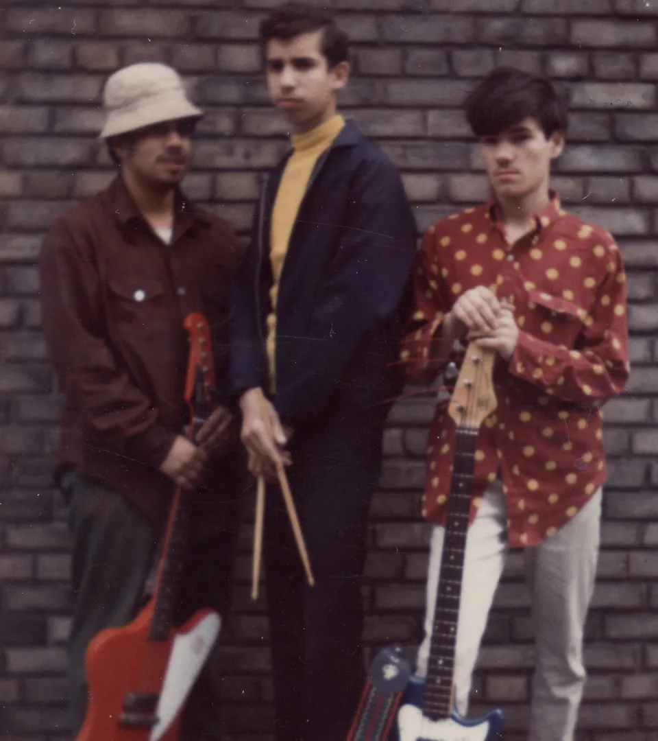 Three musicians posing together
