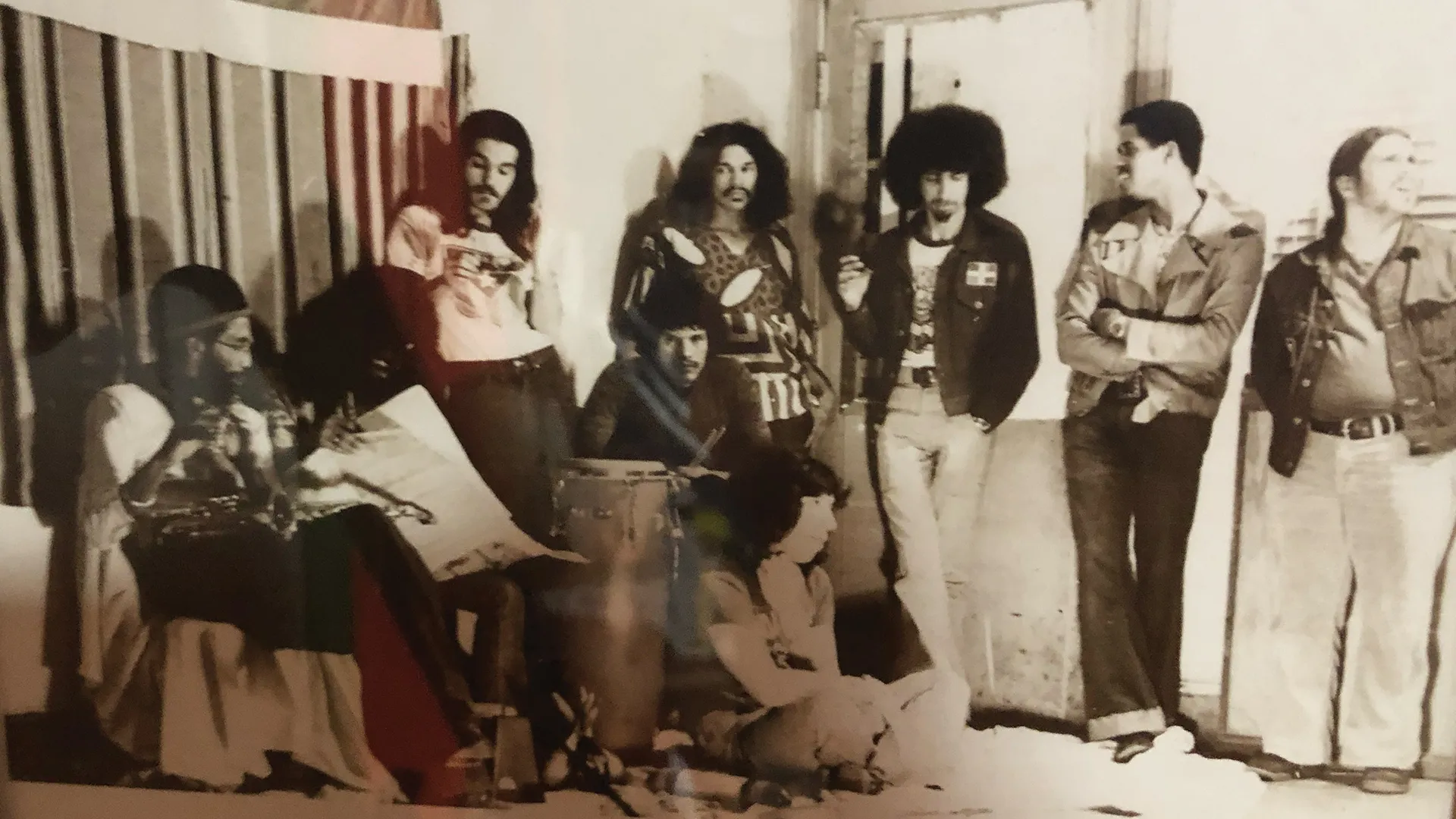 Full band posed together before a performance