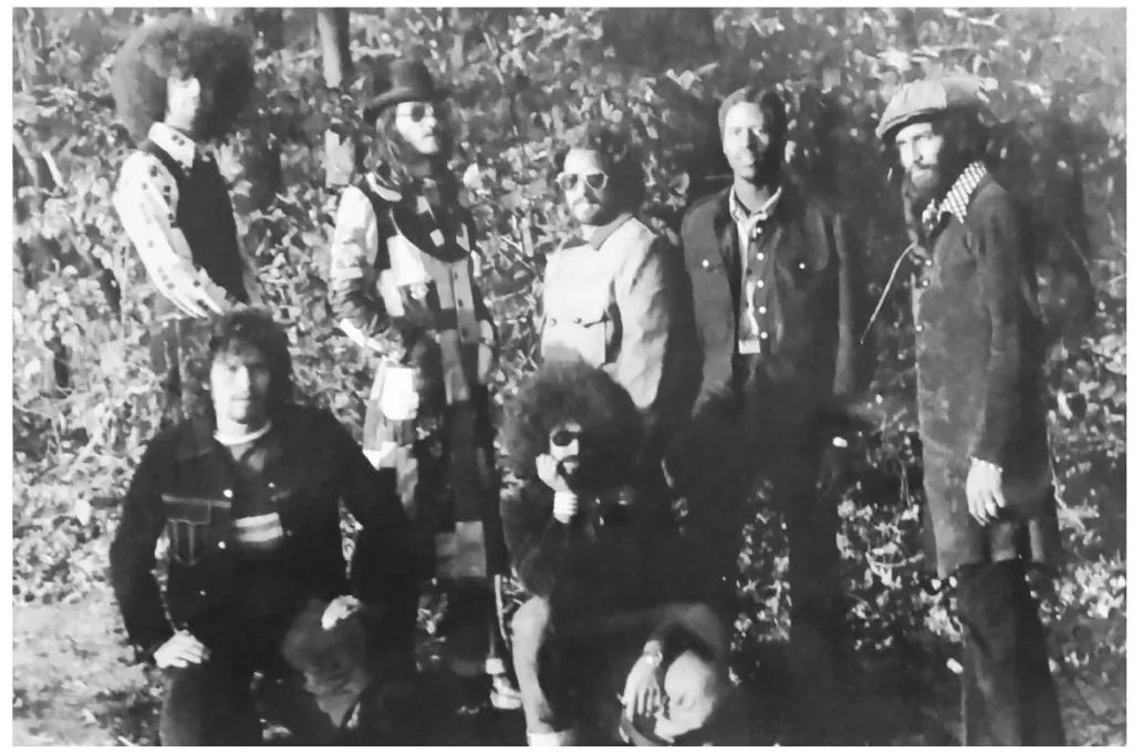 Black and white outdoor group portrait of Zapata standing and seated among trees